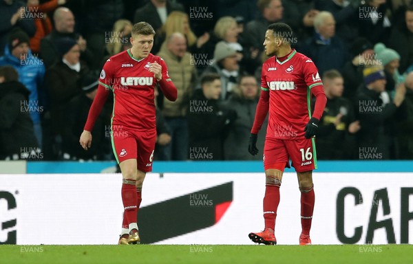 130118 - Newcastle United v Swansea City - Premier League -  Alfie Mawson (l) and Martin Olsson of Swansea City after conceding