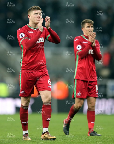 130118 - Newcastle United v Swansea City - Premier League -  Alfie Mawson (l) and Tom Carroll of Swansea City thank the fans after the full time whistle