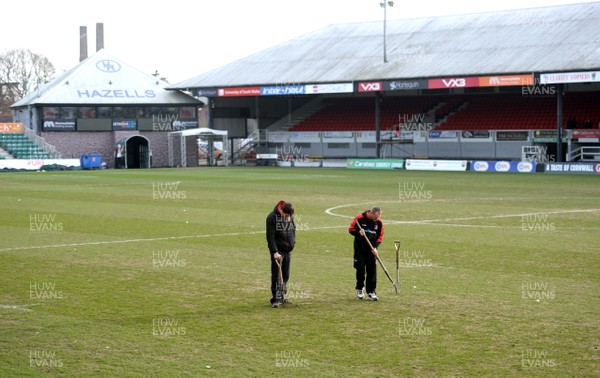 130219 - Newport County AFC Media Day - A general view of ground staff tending to the pitch at Rodney Parade, Newport