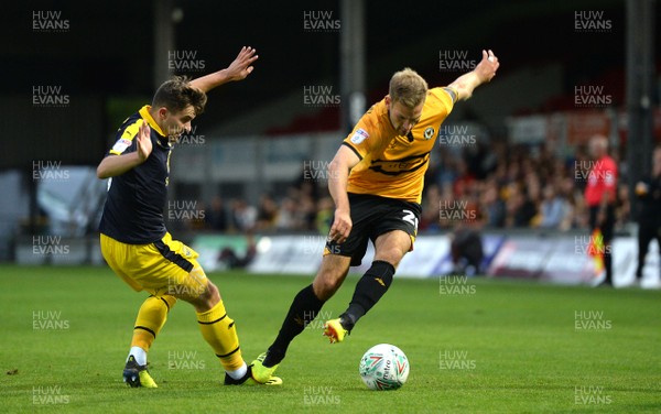 280818 - Newport County v Oxford United - Carabao Cup - Mickey Demetriou of Newport County is tackled by Jamie Hanson of Oxford United