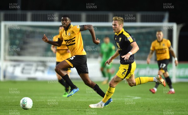 280818 - Newport County v Oxford United - Carabao Cup - Tyreeq Bakinson of Newport County tries to get away from Cameron Norman of Oxford United