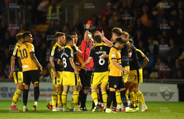 280818 - Newport County v Oxford United - Carabao Cup - Jamie Hanson (6) of Oxford United is shown a red card