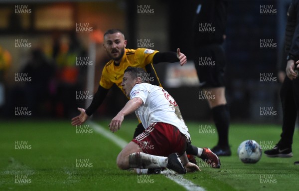 240418 - Newport County v Accrington Stanley - SkyBet League 2 - Dan Butler of Newport County is tackled by Scott Brown of Accrington Stanley