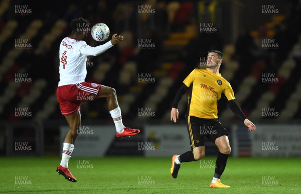 240418 - Newport County v Accrington Stanley - SkyBet League 2 - Janoi Donacien of Accrington Stanley is tackled by Padraig Amond of Newport County