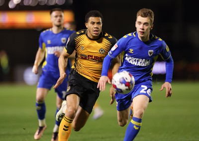 140323 - Newport County v AFC Wimbledon, EFL Sky Bet League 2 - Priestley Farquharson of Newport County and Jack Currie of AFC Wimbledon compete for the ball