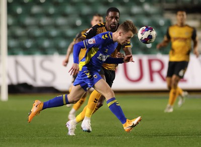 140323 - Newport County v AFC Wimbledon, EFL Sky Bet League 2 - Jack Currie of AFC Wimbledon beats Omar Bogle of Newport County to the ball