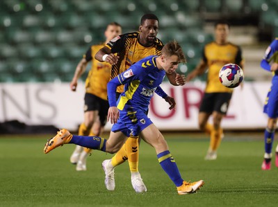 140323 - Newport County v AFC Wimbledon, EFL Sky Bet League 2 - Jack Currie of AFC Wimbledon beats Omar Bogle of Newport County to the ball