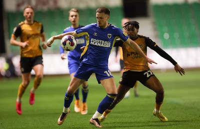 140323 - Newport County v AFC Wimbledon, EFL Sky Bet League 2 - Armani Little of AFC Wimbledon and Nathan Moriah-Welsh of Newport County compete for the ball