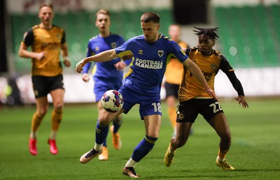 140323 - Newport County v AFC Wimbledon, EFL Sky Bet League 2 - Armani Little of AFC Wimbledon and Nathan Moriah-Welsh of Newport County compete for the ball