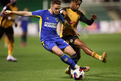 140323 - Newport County v AFC Wimbledon, EFL Sky Bet League 2 - Armani Little of AFC Wimbledon and Nathan Moriah-Welsh of Newport County compete for the ball