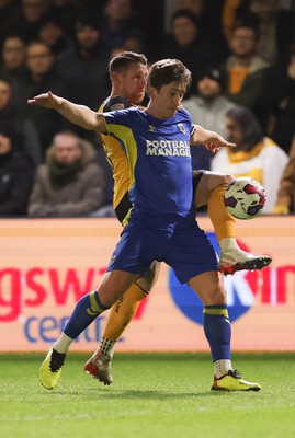 140323 - Newport County v AFC Wimbledon, EFL Sky Bet League 2 - Scot Bennett of Newport County challenges Alex Woodyard of AFC Wimbledon