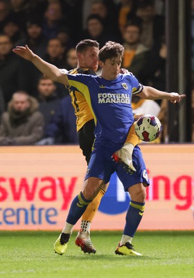 140323 - Newport County v AFC Wimbledon, EFL Sky Bet League 2 - Scot Bennett of Newport County challenges Alex Woodyard of AFC Wimbledon