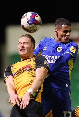 140323 - Newport County v AFC Wimbledon, EFL Sky Bet League 2 - Cameron Norman of Newport County and Ali Al-Hamadi of AFC Wimbledon compete for the ball