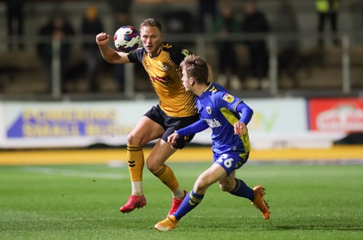 140323 - Newport County v AFC Wimbledon, EFL Sky Bet League 2 - Cameron Norman of Newport County takes on Jack Currie of AFC Wimbledon