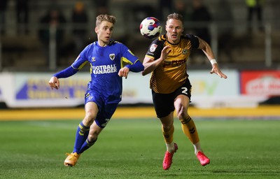 140323 - Newport County v AFC Wimbledon, EFL Sky Bet League 2 - Cameron Norman of Newport County takes on Jack Currie of AFC Wimbledon