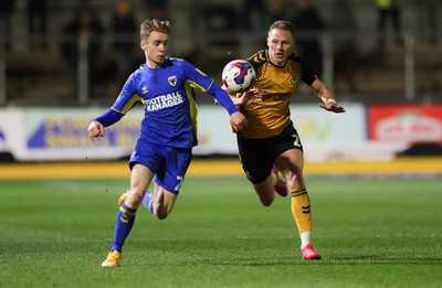 140323 - Newport County v AFC Wimbledon, EFL Sky Bet League 2 - Cameron Norman of Newport County takes on Jack Currie of AFC Wimbledon