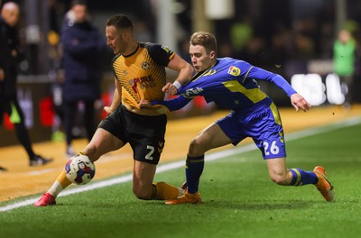 140323 - Newport County v AFC Wimbledon, EFL Sky Bet League 2 - Cameron Norman of Newport County takes on Jack Currie of AFC Wimbledon