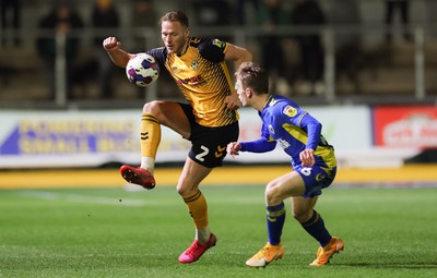 140323 - Newport County v AFC Wimbledon, EFL Sky Bet League 2 - Cameron Norman of Newport County takes on Jack Currie of AFC Wimbledon