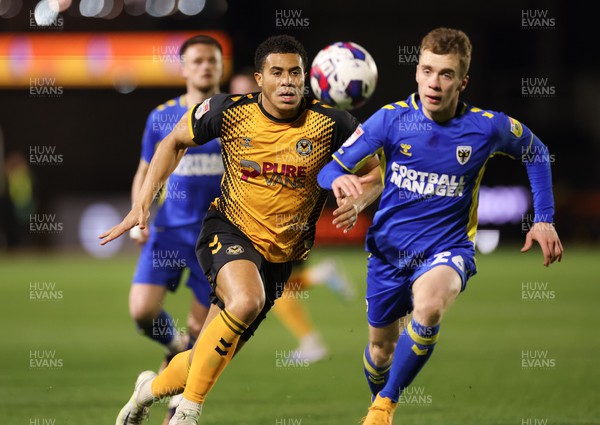 140323 - Newport County v AFC Wimbledon, EFL Sky Bet League 2 - Priestley Farquharson of Newport County and Jack Currie of AFC Wimbledon compete for the ball