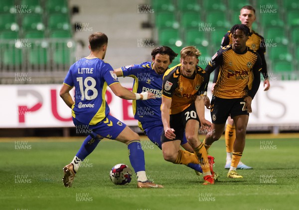 140323 - Newport County v AFC Wimbledon, EFL Sky Bet League 2 - Harry Charsley of Newport County takes on Ethan Chislett of AFC Wimbledon and Armani Little of AFC Wimbledon