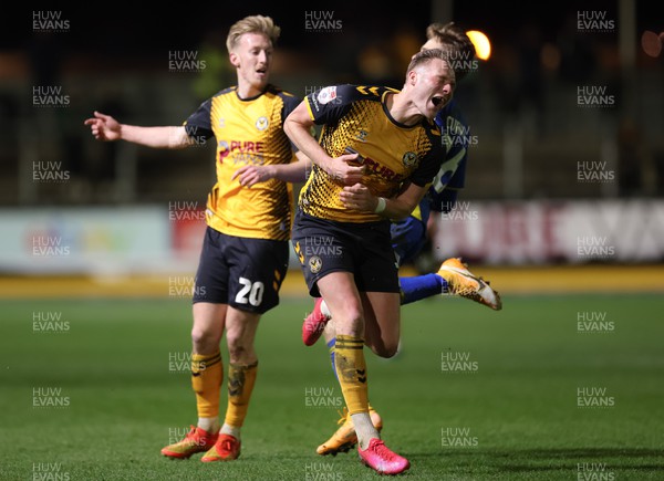 140323 - Newport County v AFC Wimbledon, EFL Sky Bet League 2 - Cameron Norman of Newport County takes a kick to the chest from Jack Currie of AFC Wimbledon as he looks to win the ball
