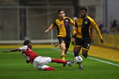 230925 - Newport County v Arsenal U21 - Vertu Trophy - Bobby Kamwa of Newport County is tackled by Josh Nicols of Arsenal U21s