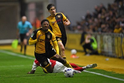 230925 - Newport County v Arsenal U21 - Vertu Trophy - Bobby Kamwa of Newport County is tackled by Josh Nicols of Arsenal U21s