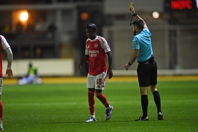 230925 - Newport County v Arsenal U21 - Vertu Trophy -  Josh Nicols of Arsenal U21s is shown a yellow card