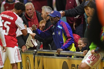 230925 - Newport County v Arsenal U21 - Vertu Trophy - Social Media figure and Arsenal Fan TV contributor, Tai Ogunlabi “Ty” celebrates the sides win at full time with the players