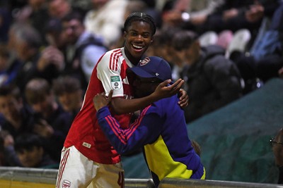 230925 - Newport County v Arsenal U21 - Vertu Trophy - Josh Nicols of Arsenal U21s is congratulated by Social Media figure and Arsenal Fan TV contributor, Tai Ogunlabi “Ty” as he leaves the field