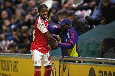 230925 - Newport County v Arsenal U21 - Vertu Trophy - Josh Nicols of Arsenal U21s is congratulated by Social Media figure and Arsenal Fan TV contributor, Tai Ogunlabi “Ty” as he leaves the field