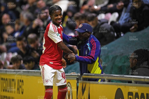 230925 - Newport County v Arsenal U21 - Vertu Trophy - Josh Nicols of Arsenal U21s is congratulated by Social Media figure and Arsenal Fan TV contributor, Tai Ogunlabi “Ty” as he leaves the field