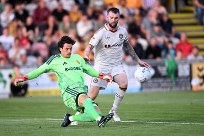 040826 - Newport County v AS Roma - Pre-Season Friendly - Mile Svilar of Roma is challenged by Kyle Cameron of Newport County
