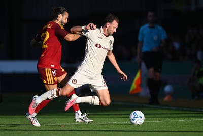 040826 - Newport County v AS Roma - Pre-Season Friendly - Christian Doidge of Newport County is challenged by Mario Hermoso of Roma