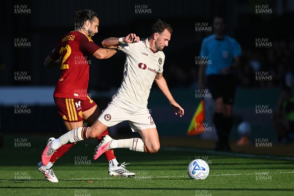 040826 - Newport County v AS Roma - Pre-Season Friendly - Christian Doidge of Newport County is challenged by Mario Hermoso of Roma