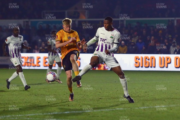 021223 - Newport County v Barnet - FA Cup Second Round - Will Evans of Newport County is beaten to the ball by Jerome Okimo of Barnet