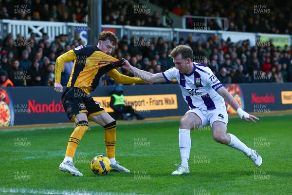 261225 - Newport County v Barnet - Sky Bet League 2 - Michael Spellman of Newport County is tackled by Danny Collinge of Barnet