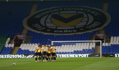 090321 Newport County v Bradford City, Sky Bet League 2 - Newport County huddle up in front of  giant club crest as they play their League 2 match against Bradford at Cardiff City Stadium due to the poor state of the pitch at Rodney Parade