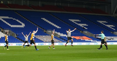 090321 Newport County v Bradford City, Sky Bet League 2 - Referee Will Finnie points to the penalty spot as Newport County players appeal for a penalty in the final minutes of the match