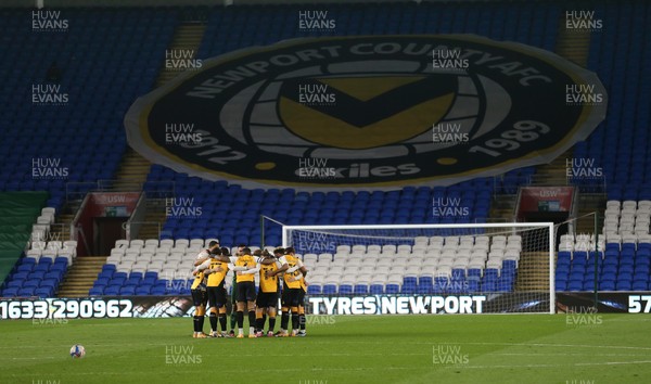 090321 Newport County v Bradford City, Sky Bet League 2 - Newport County huddle up in front of  giant club crest as they play their League 2 match against Bradford at Cardiff City Stadium due to the poor state of the pitch at Rodney Parade