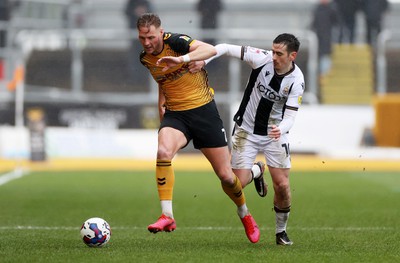 110323 - Newport County v Bradford City - SkyBet League Two - Cameron Norman of Newport County is challenged by Jamie Walker of Bradford City 