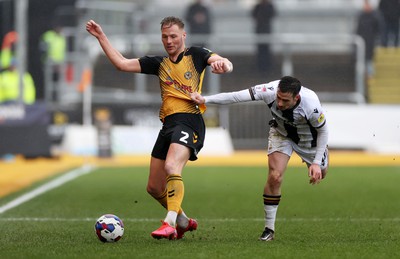 110323 - Newport County v Bradford City - SkyBet League Two - Cameron Norman of Newport County is challenged by Jamie Walker of Bradford City 