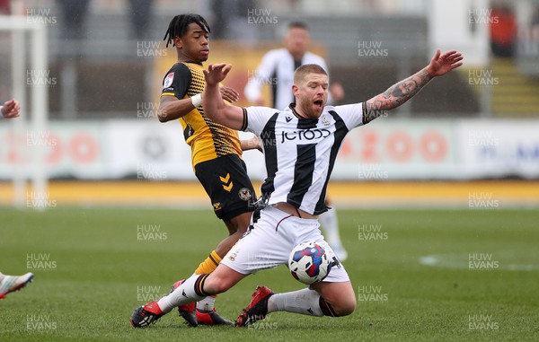 110323 - Newport County v Bradford City - SkyBet League Two - Adam Clayton of Bradford City is tackled by Nathan Moriah-Welsh of Newport County