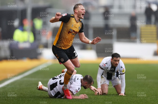 110323 - Newport County v Bradford City - SkyBet League Two - Cameron Norman of Newport County is tackled by Liam Ridehalgh of Bradford City