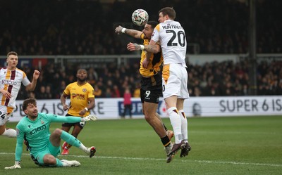 150225  Newport County v Bradford City, EFL Sky Bet League 2 - Courtney Baker-Richardson of Newport County looks to head at goal as Paul Huntington of Bradford City challenges