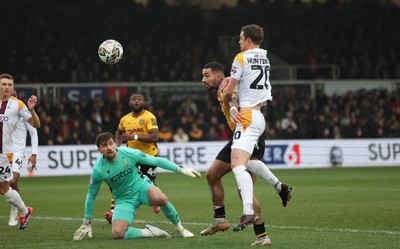 150225  Newport County v Bradford City, EFL Sky Bet League 2 - Courtney Baker-Richardson of Newport County looks to head at goal as Paul Huntington of Bradford City challenges