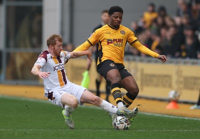 150225  Newport County v Bradford City, EFL Sky Bet League 2 - Bobby Kamwa of Newport County is tackled by Brad Halliday of Bradford City