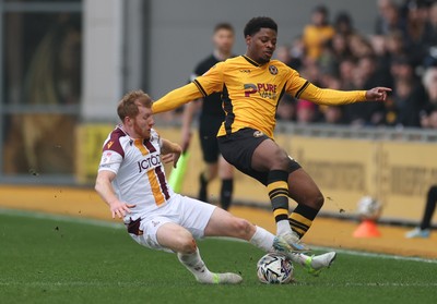 150225  Newport County v Bradford City, EFL Sky Bet League 2 - Bobby Kamwa of Newport County is tackled by Brad Halliday of Bradford City