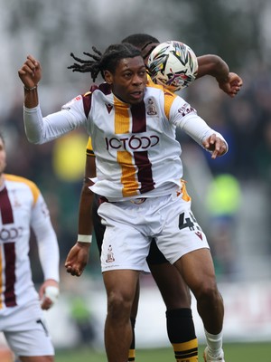 150225  Newport County v Bradford City, EFL Sky Bet League 2 - Tayo Adaramola of Bradford City beats David Ajiboye of Newport County to win the ball