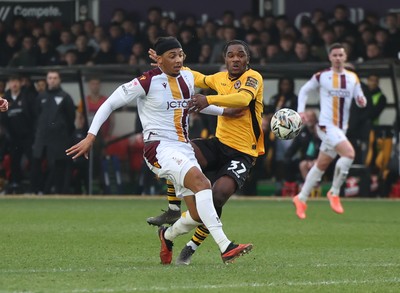 150225  Newport County v Bradford City, EFL Sky Bet League 2 - Geoffroy Bony of Newport County is brought down by Tommy Leigh of Bradford City